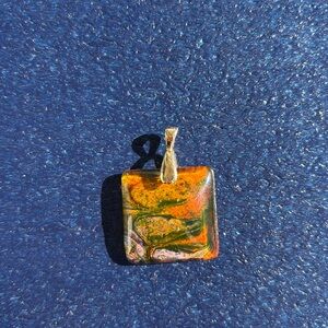 Square pendant with oranges, yellow, purples, and browns, goldtone bail